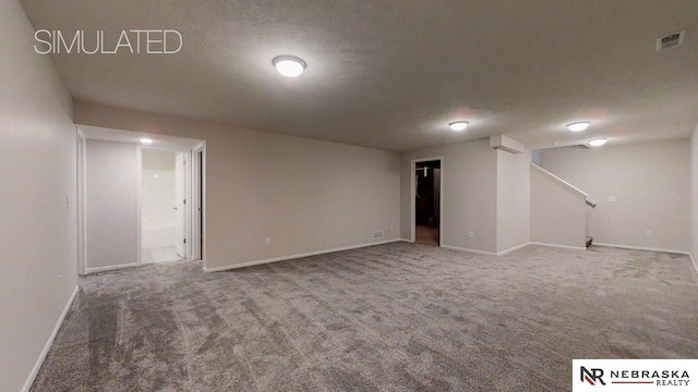 basement with carpet flooring and a textured ceiling