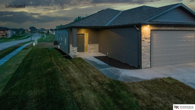 property exterior at dusk with a garage and a lawn