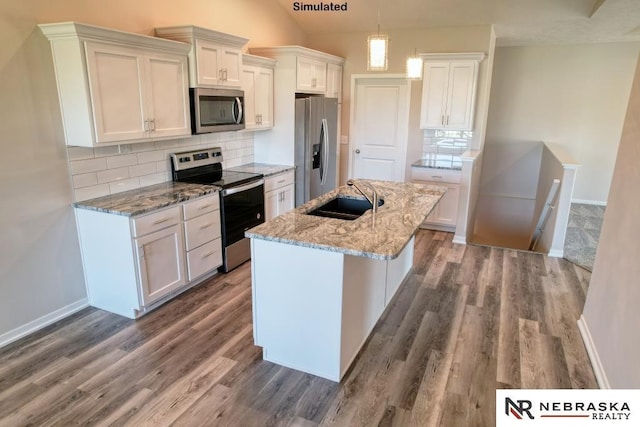 kitchen with pendant lighting, sink, appliances with stainless steel finishes, white cabinetry, and a kitchen island with sink