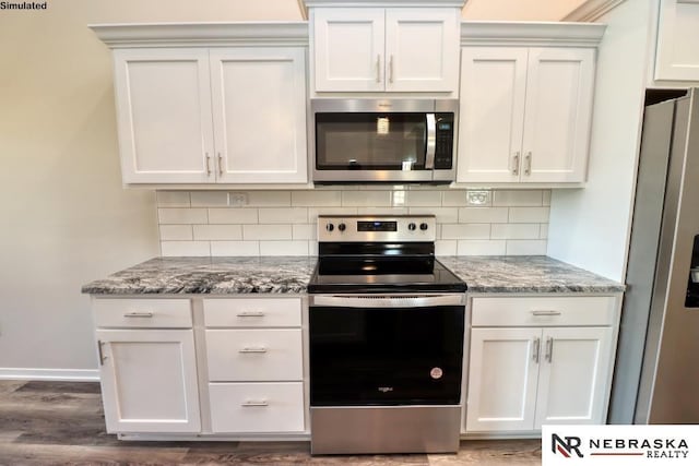 kitchen featuring light stone counters, appliances with stainless steel finishes, backsplash, and white cabinets