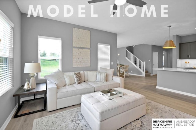 living room featuring light hardwood / wood-style flooring and ceiling fan