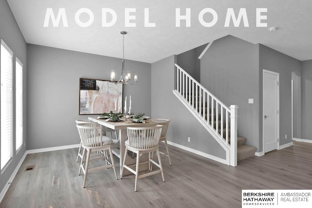 dining room featuring hardwood / wood-style floors, a wealth of natural light, and a chandelier