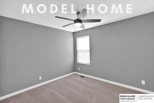 empty room featuring ceiling fan and carpet