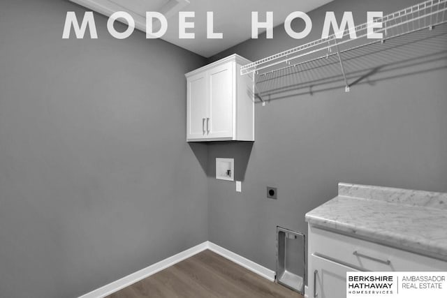 clothes washing area featuring hookup for a washing machine, dark hardwood / wood-style floors, hookup for an electric dryer, and cabinets