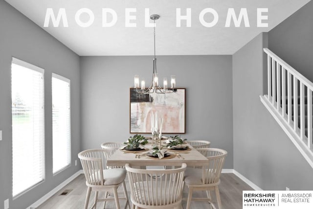 dining area featuring hardwood / wood-style flooring, a chandelier, and a healthy amount of sunlight