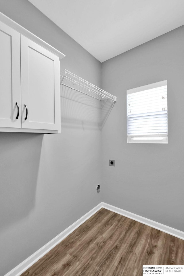 laundry area featuring cabinets, dark wood-type flooring, and hookup for an electric dryer