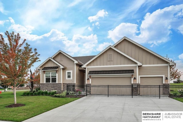 craftsman-style home with a front yard and a garage