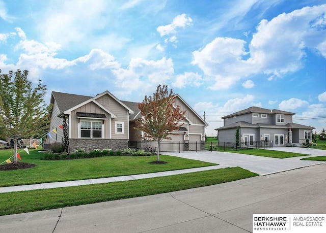 craftsman-style house with a front yard and a garage