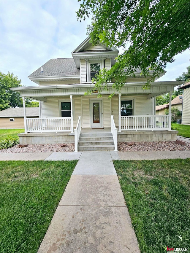 view of front of home with a front lawn and a porch