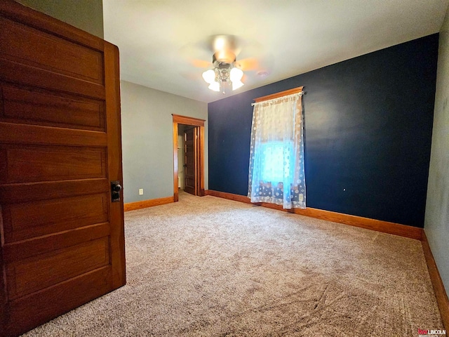 empty room with ceiling fan and carpet floors