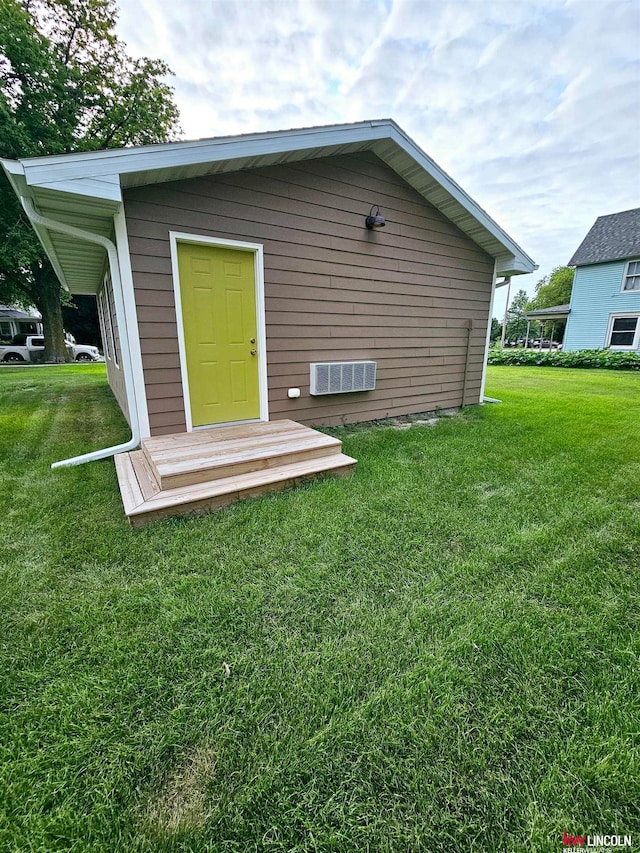 rear view of property featuring a yard