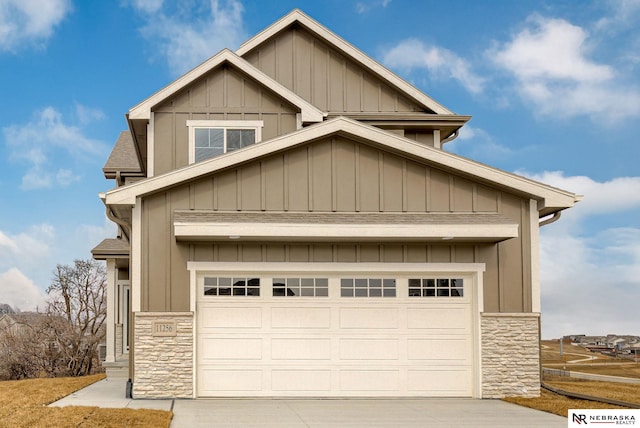 exterior space with board and batten siding, stone siding, and driveway