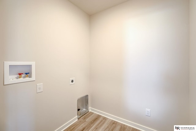 clothes washing area with hookup for an electric dryer, light wood-type flooring, and washer hookup