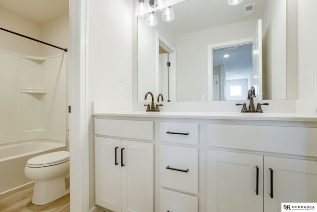 full bathroom featuring shower / tub combination, double sink vanity, toilet, and wood-type flooring