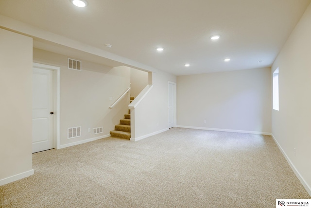 basement featuring light carpet