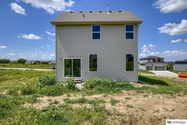 back of house featuring a garage