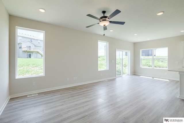 unfurnished room featuring ceiling fan and light hardwood / wood-style floors