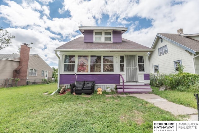 bungalow-style house with a front lawn