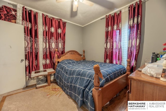 bedroom with ceiling fan and ornamental molding