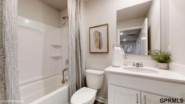 full bathroom with shower / bath combo with shower curtain, vanity, and toilet