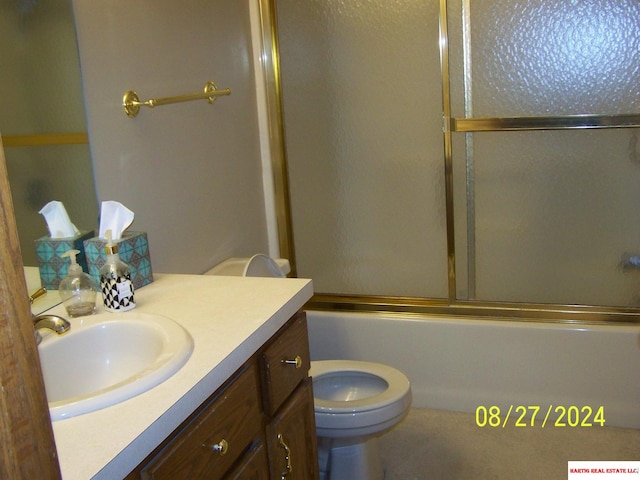 full bathroom featuring toilet, vanity, and enclosed tub / shower combo