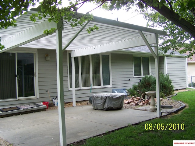 back of property featuring a pergola and a patio area