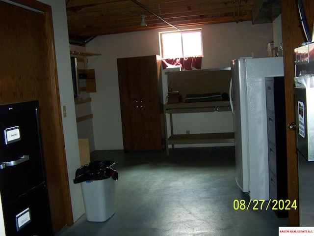 kitchen with concrete floors and white refrigerator