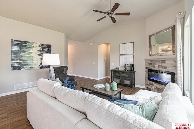 living area featuring baseboards, visible vents, a ceiling fan, dark wood-type flooring, and a stone fireplace