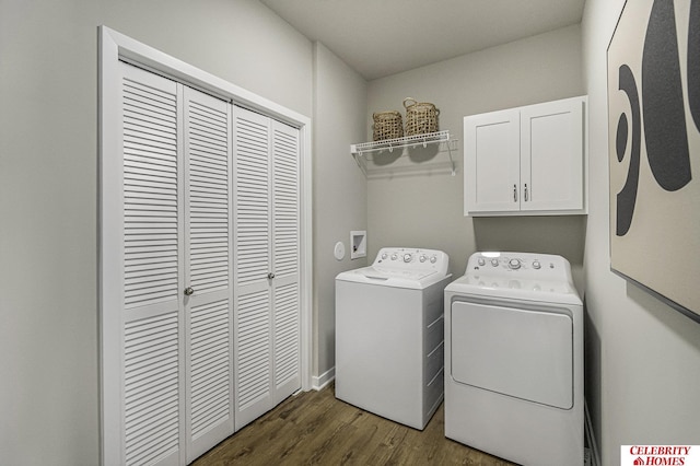 clothes washing area with cabinet space, dark wood-style floors, and washer and clothes dryer