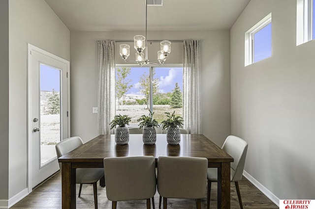 dining area with a chandelier, visible vents, dark wood finished floors, and baseboards