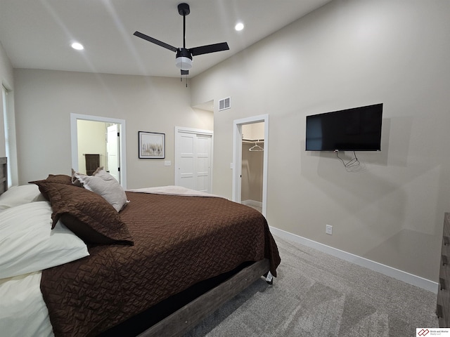 carpeted bedroom with a high ceiling and ceiling fan