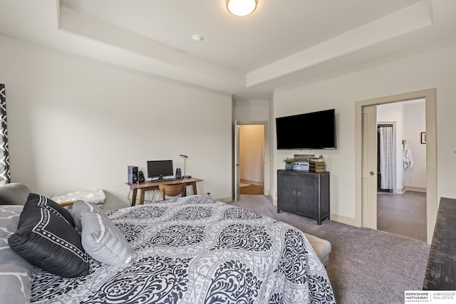 bedroom featuring carpet flooring and a tray ceiling