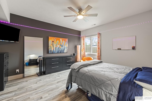 bedroom with ceiling fan and wood-type flooring