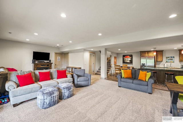 carpeted living room with wet bar