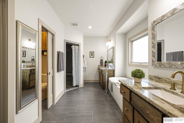 bathroom featuring vanity and toilet