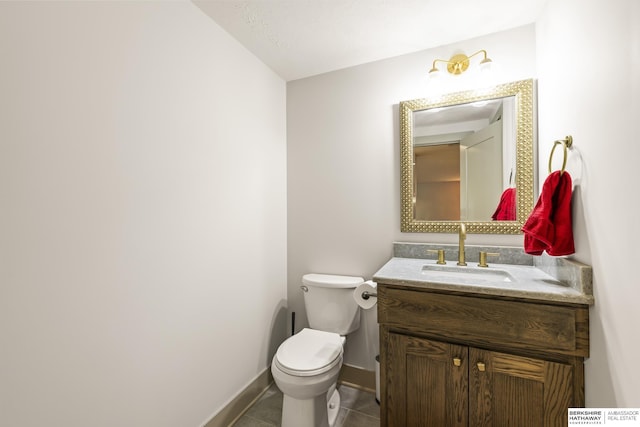 bathroom featuring tile patterned flooring, vanity, and toilet