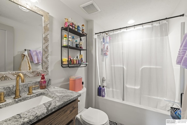 full bathroom with vanity, shower / tub combo with curtain, and toilet