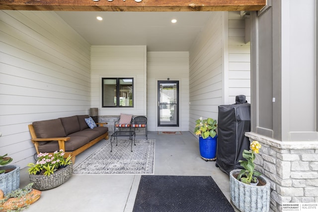 entrance to property with outdoor lounge area and a patio