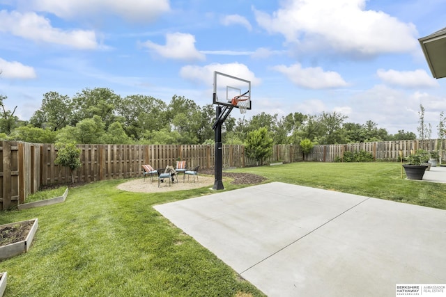 view of sport court featuring a lawn