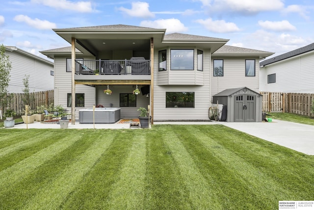 rear view of house featuring a patio, a balcony, a storage unit, a hot tub, and central AC