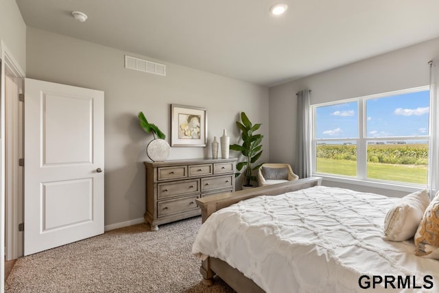 bedroom featuring light carpet, baseboards, and visible vents