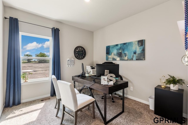 carpeted office space featuring visible vents and baseboards