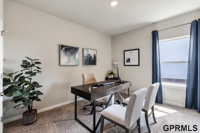 office featuring baseboards, a wealth of natural light, and light colored carpet