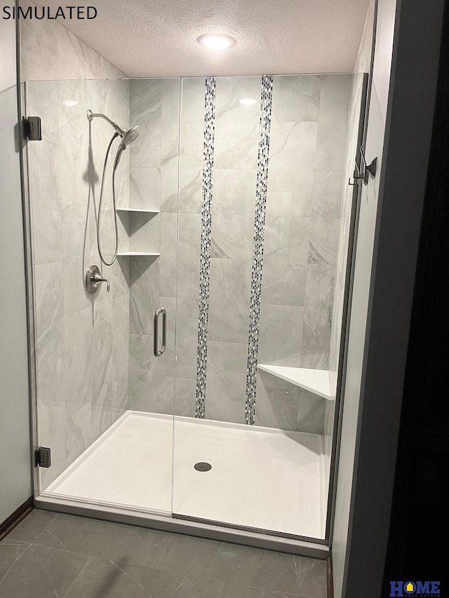 bathroom featuring tile patterned floors, a textured ceiling, and a shower with shower door