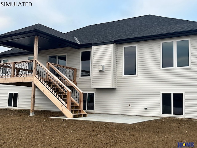 back of property featuring a wooden deck and a patio area