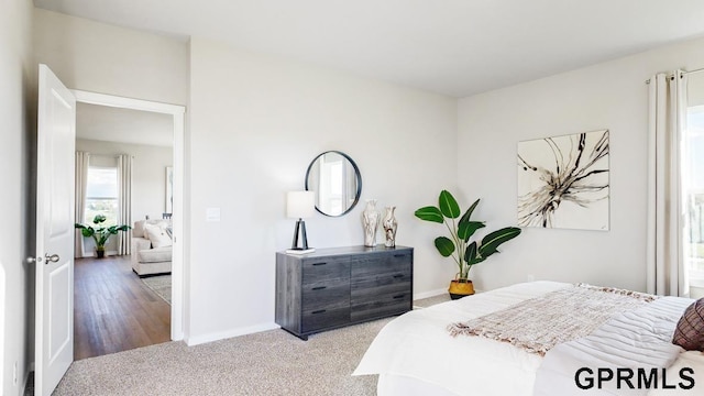 bedroom featuring light colored carpet