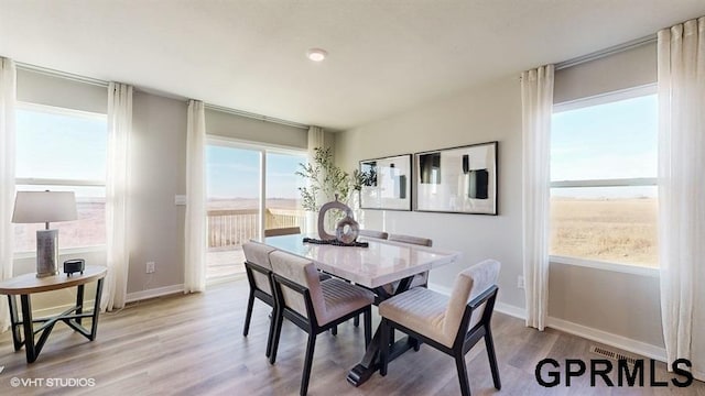 dining space featuring light wood-type flooring