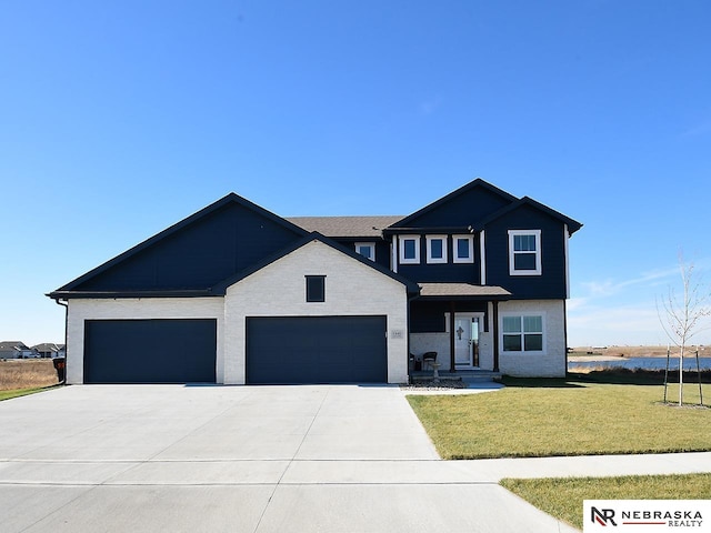 view of front of house with a garage and a front yard