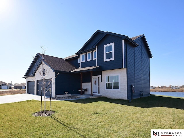 view of front of home with a garage and a front lawn