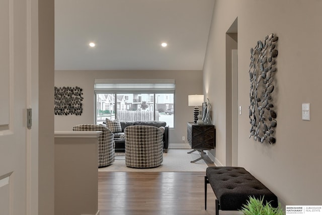 interior space featuring baseboards, wood finished floors, lofted ceiling, and recessed lighting